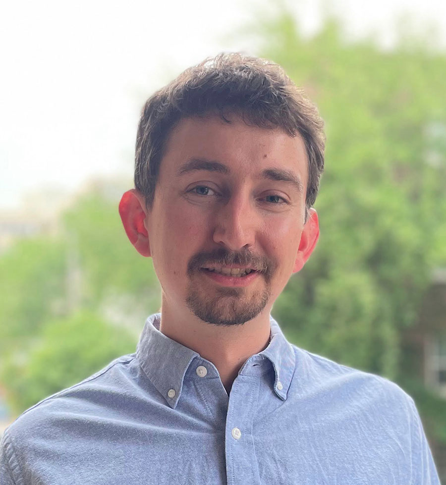 Headshot of Daniel Fried wearing a blue dress shirt