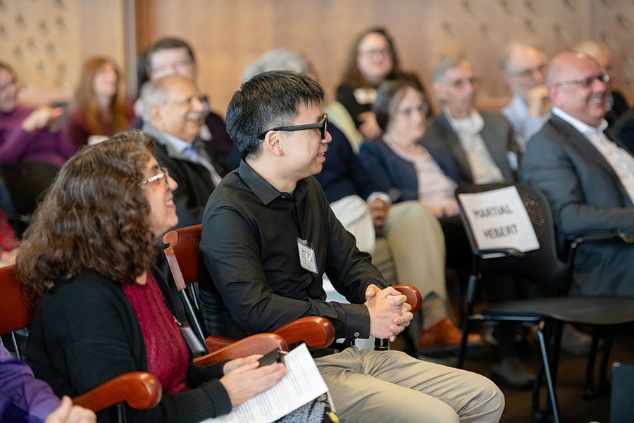 Candid shot of Carolyn Rose and Jun-Yan Zhu seated in an auditorium
